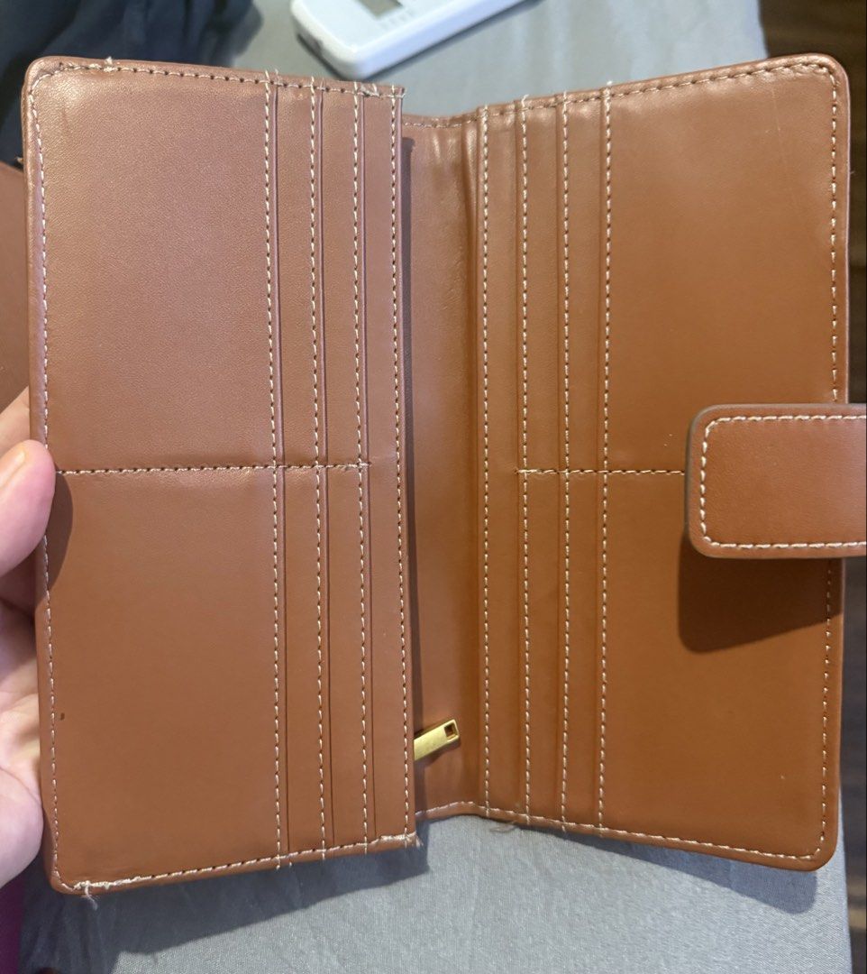 MNG Mango Brown Canvas Long Wallet (Category: Wallets & Card holders) located in Cainta. Submitted by mykee1 (Listing ID 1468372808, Image 2). Description: - Brand: Mango - Style: Long wallet in cream canvas and brown faux leather - Hardware: Gold-toned MNG logo plaque - Closure: Secure side snap button tab - Design: Classic rectangle shape with contrast white stitching - Condition: Brand new / Excellent - Mode of Payment: BPI, BDO, Gcash - Shipp