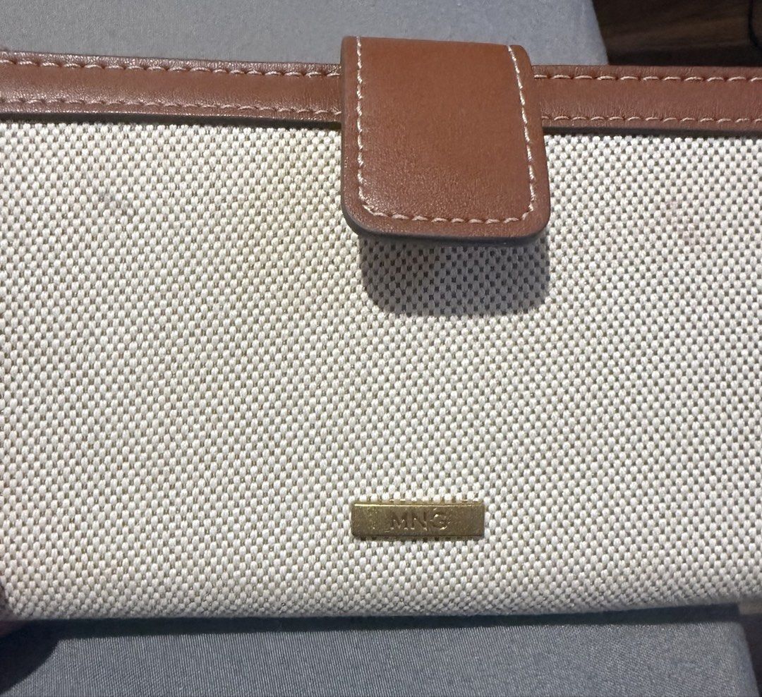 MNG Mango Brown Canvas Long Wallet (Category: Wallets & Card holders) located in Cainta. Submitted by mykee1 (Listing ID 1468372808, Image 3). Description: - Brand: Mango - Style: Long wallet in cream canvas and brown faux leather - Hardware: Gold-toned MNG logo plaque - Closure: Secure side snap button tab - Design: Classic rectangle shape with contrast white stitching - Condition: Brand new / Excellent - Mode of Payment: BPI, BDO, Gcash - Shipp