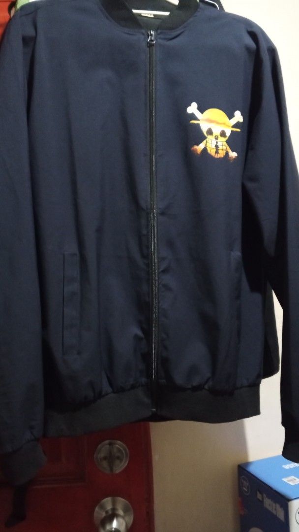 Money Heist / One Piece Bomber Jacket Black (Category: Coats, Jackets and Outerwear) located in Paranaque City. Submitted by blessolivar (Listing ID 1468362738, Image 2). Description: Color: Black Style: Zip-up bomber jacket with ribbed collar, cuffs, and hem Front Desig on the chest - Back Design: Large, vibrant La Casa de Papel character graphic and logo - Condition: Brand new / Excellent quality .