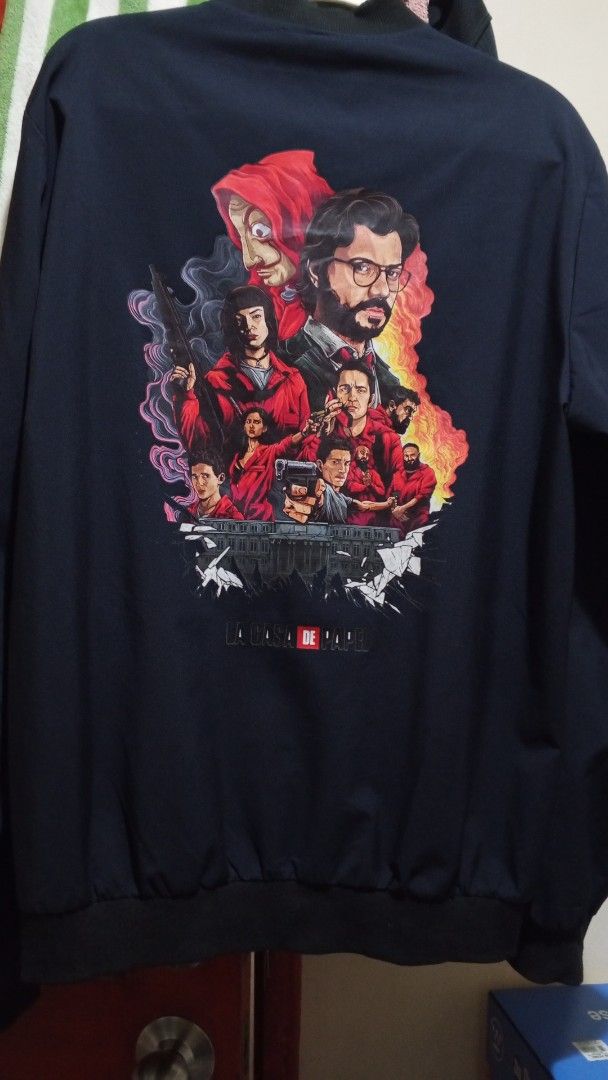 Money Heist / One Piece Bomber Jacket Black (Category: Coats, Jackets and Outerwear) located in Paranaque City. Submitted by blessolivar (Listing ID 1468362738, Image 3). Description: Color: Black Style: Zip-up bomber jacket with ribbed collar, cuffs, and hem Front Desig on the chest - Back Design: Large, vibrant La Casa de Papel character graphic and logo - Condition: Brand new / Excellent quality .