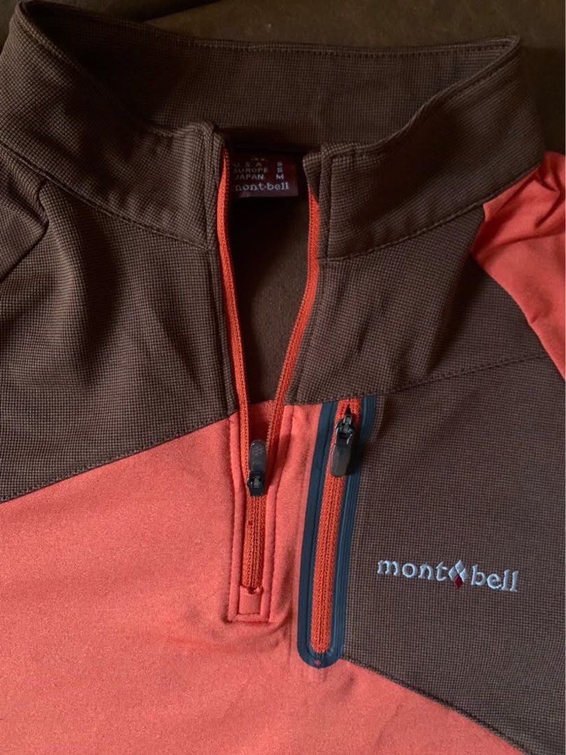 Montbell Quarter-Zip Fleece (Category: Coats, Jackets and Outerwear) located in Iloilo. Submitted by astaaa777 (Listing ID 1468322025, Image 2). Description: - Brand: Montbell - Style: Quarter-zip pullover midlayer - Color: Brown and orange color blocking - Material: Warm grid fleece on upper body and collar - Features: Zipped chest pocket with embroidered Montbell logo - Condition: Excellent outdoor wear - Perfect for: Hiking, camping, and cold-