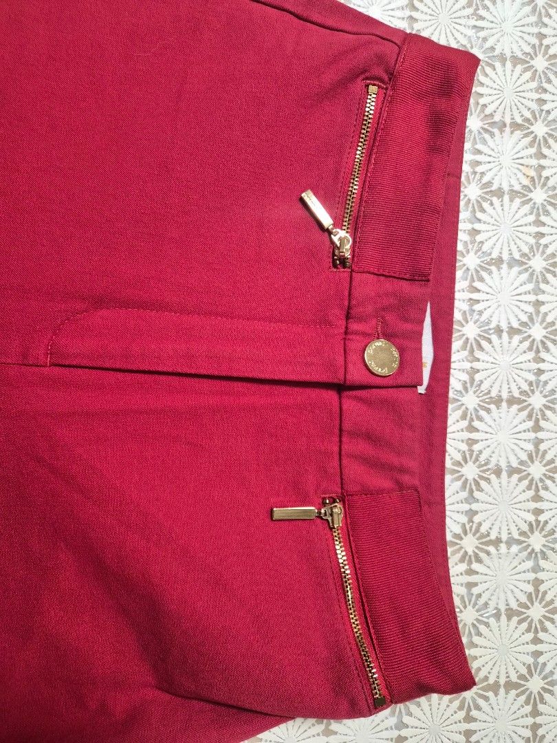 M&S Red Trousers Pants UK 8 (Category: Jeans) located in Manila. Submitted by prelovedbyc.hannah (Listing ID 1468434479, Image 3). Description: - Brand: Marks & Spencer - Color: Vibrant red - Size: UK 8 / EUR 36 (Short length) - Closure: Single button at the waist - Details: Front side zip pockets with stylish gold hardware - Condition: Clean fabric, great for work or casual wear.