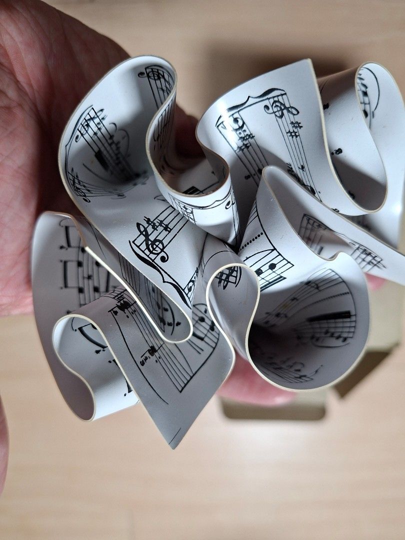 Music Sheet Design Paper Weight (Category: Musical Instruments) located in Baguio. Submitted by restyrille77846 (Listing ID 1468324586, Image 2). Description: - Made from unique rolled musical score paper - Compact size holds down loose documents without taking up space - Fun conversation piece for musicians and music lovers - Comes with original cardboard box labeled "Paper Weight" - Keeps your workspace organized in style.