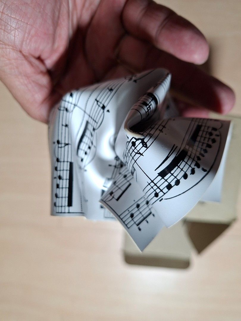 Music Sheet Design Paper Weight (Category: Musical Instruments) located in Baguio. Submitted by restyrille77846 (Listing ID 1468324586, Image 3). Description: - Made from unique rolled musical score paper - Compact size holds down loose documents without taking up space - Fun conversation piece for musicians and music lovers - Comes with original cardboard box labeled "Paper Weight" - Keeps your workspace organized in style.