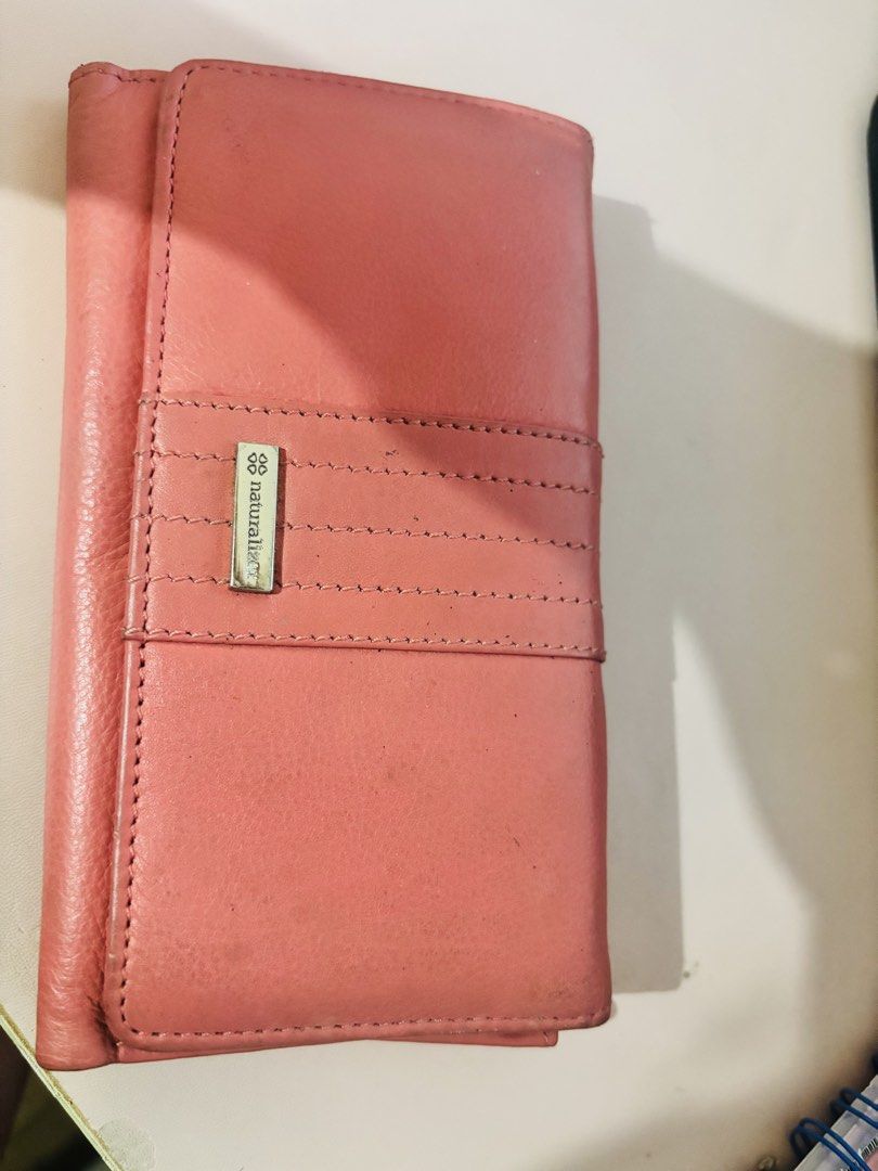 Naturalizer Pink Leather Long Wallet (Category: Wallets & Card holders) located in Cavite. Submitted by gianflores (Listing ID 1468471674, Image 1). Description: - Brand: Naturalizer - Material: Pink leather with silver-tone hardware branding plate - Closure: Snap button - Features: Multiple card slots and two clear ID windows - Condition: Shows minor signs of wear and light marks on the exterior and interior - Storage: Great capacity for cards, 
