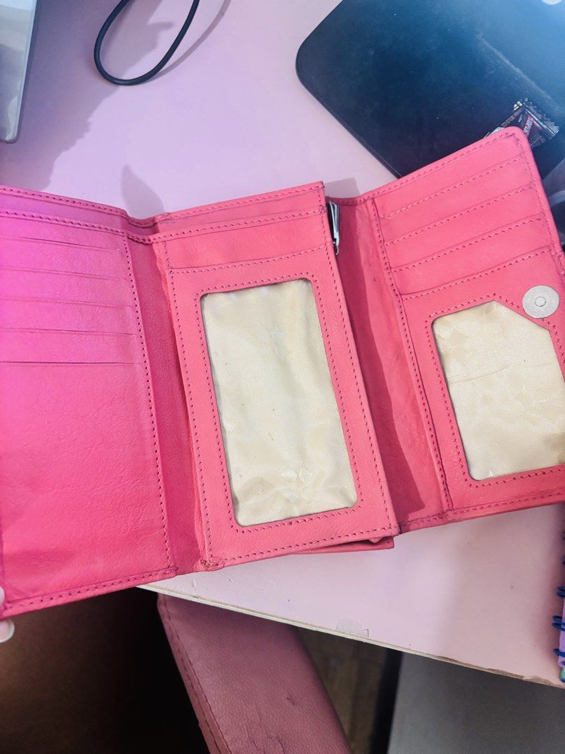 Naturalizer Pink Leather Long Wallet (Category: Wallets & Card holders) located in Cavite. Submitted by gianflores (Listing ID 1468471674, Image 2). Description: - Brand: Naturalizer - Material: Pink leather with silver-tone hardware branding plate - Closure: Snap button - Features: Multiple card slots and two clear ID windows - Condition: Shows minor signs of wear and light marks on the exterior and interior - Storage: Great capacity for cards, 