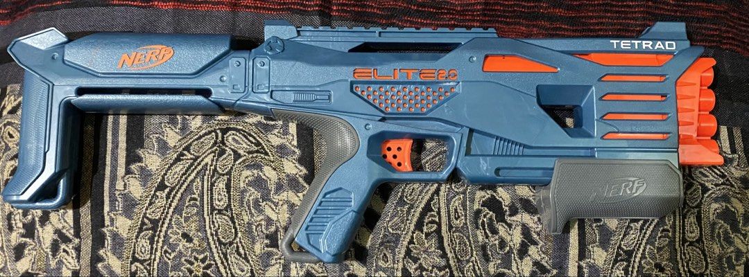 Nerf Elite 2.0 Tetrad Blaster (Category: Action & Battle Toys) located in Baguio. Submitted by thrift_bonita (Listing ID 1468385999, Image 1). Description: - Model: Nerf Elite 2.0 Tetrad toy blaster (Blue and orange) - Firepower: 4 vertical barrels up front for quick successive shots - Action: Pump-action handle and manual trigger, fully functional - Design: Fixed stock at the back with official branding - Condition: Clean plastic body with minor