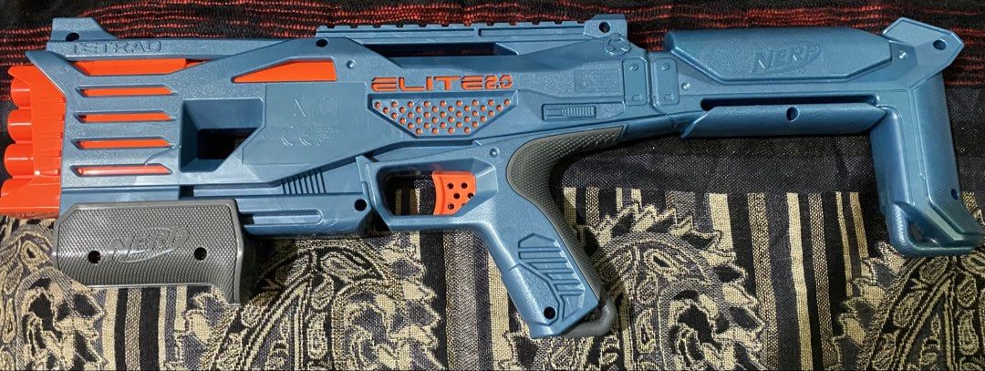Nerf Elite 2.0 Tetrad Blaster (Category: Action & Battle Toys) located in Baguio. Submitted by thrift_bonita (Listing ID 1468385999, Image 3). Description: - Model: Nerf Elite 2.0 Tetrad toy blaster (Blue and orange) - Firepower: 4 vertical barrels up front for quick successive shots - Action: Pump-action handle and manual trigger, fully functional - Design: Fixed stock at the back with official branding - Condition: Clean plastic body with minor