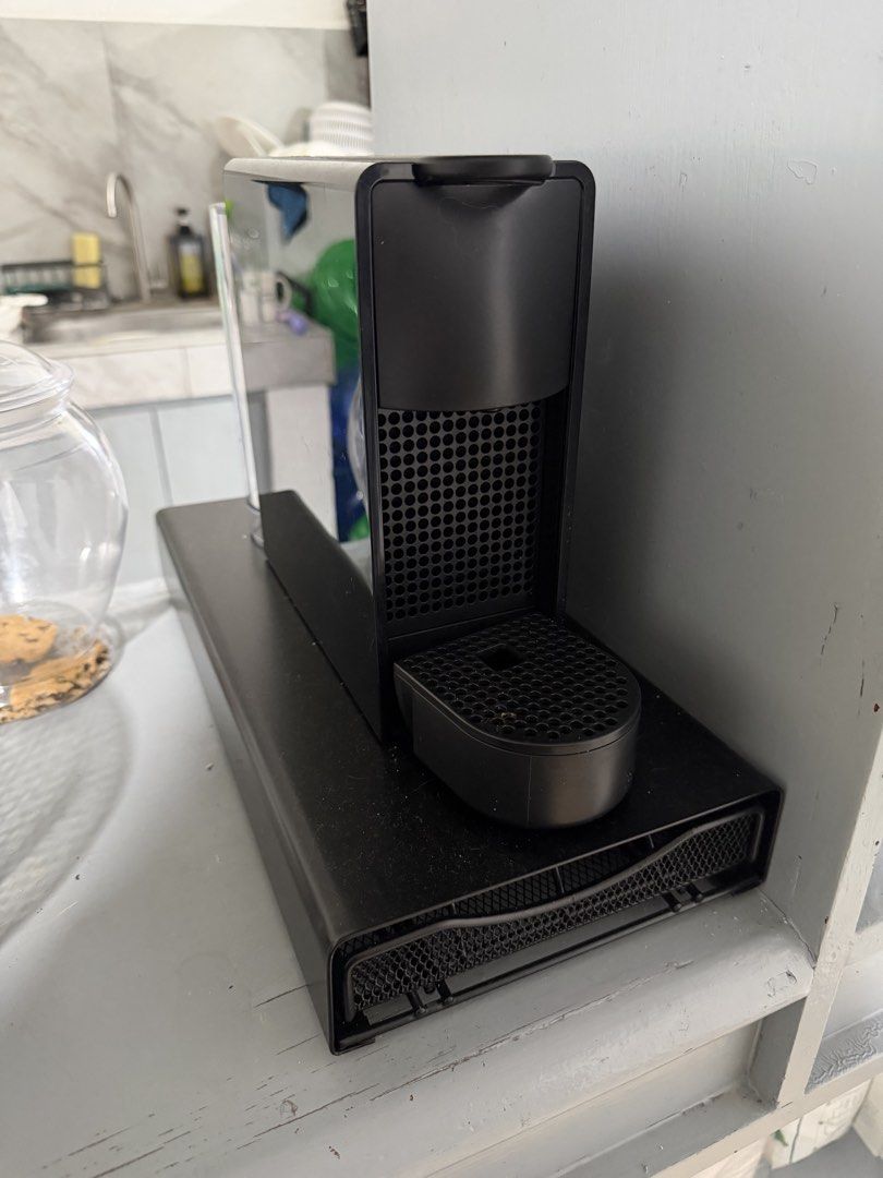 Nespresso Essenza Mini Coffee Machine with Pod Holder Base (Category: Coffee Machines & Makers) located in Bacoor. Submitted by _alkami (Listing ID 1468289833, Image 1). Description: - Nespresso Essenza Mini capsule coffee machine in sleek black - Includes matching black pod storage drawer - Slim footprint, perfect for small kitchen counters - Fast and easy espresso maker - Convenient removable water tank at the back - Excellent, clean condition 