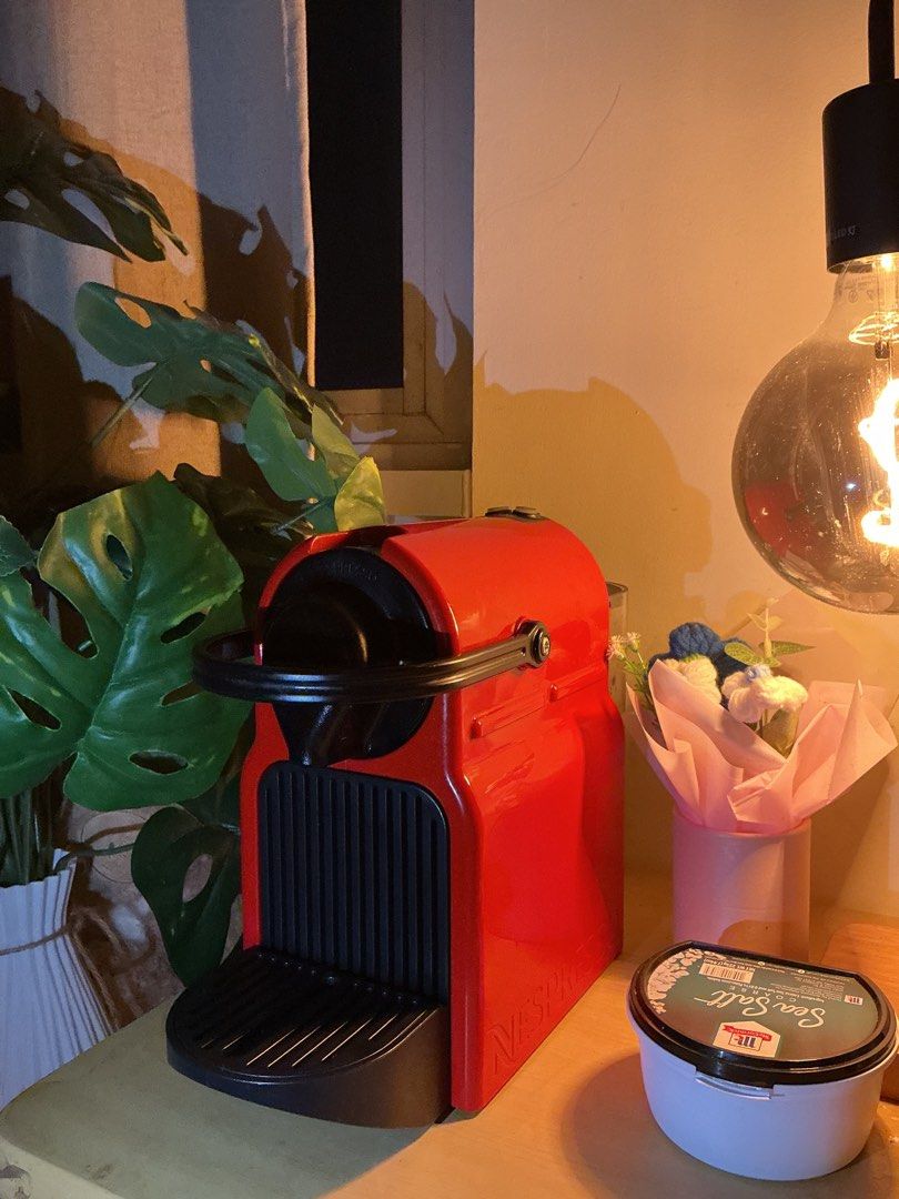 Nespresso Inissia Coffee Machine Red (Category: Coffee Machines & Makers) located in Quezon City. Submitted by elleskyer (Listing ID 1468299102, Image 2). Description: - Color: Bright red with black drip tray and lever - Design: Compact size, ideal for small kitchen counters - Performance: Works great, heats up fast for quick morning espresso shots - Maintenance: Easy-to-clean water tank located at the back - Power: Standard power plug included -