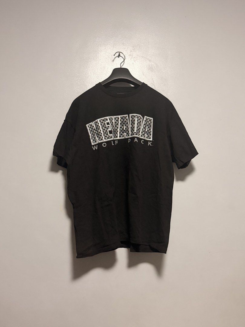 Nevada Wolf Pack Black T-Shirt XXL (Category: Tshirts & Polo Shirts ) located in Manila. Submitted by swiftgem.eeb06e (Listing ID 1468410393, Image 1). Description: - Brand: Champs Sports College Team Edition Apparel - Design: Black graphic tee with bold 'NEVADA' patterned fill and 'WOLF PACK' text - Size: XXL - Material: 100% cotton with a comfortable tagless collar - Origin: Made in Nicaragua - Condition: Excellent, ready to wear - Dimes: 24x27