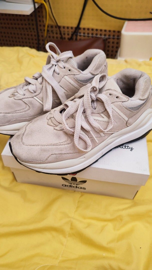 New Balance 574 Light Beige Sneakers (Category: Sneakers) located in Manila. Submitted by anez06 (Listing ID 1468351350, Image 1). Description: - Color/Material: Beige suede with chunky white midsoles - Style: Classic lace-up with signature 'N' side branding - Versatility: Neutral shade easily pairs with casual outfits - Condition: Gentle wear on suede and soles from normal use.