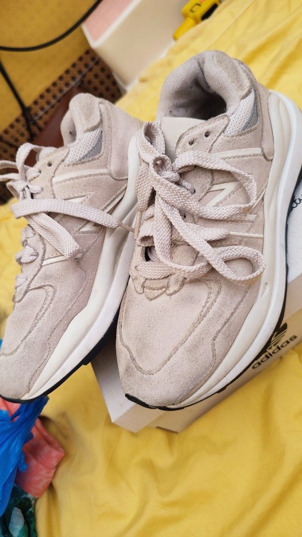 New Balance 574 Light Beige Sneakers (Category: Sneakers) located in Manila. Submitted by anez06 (Listing ID 1468351350, Image 2). Description: - Color/Material: Beige suede with chunky white midsoles - Style: Classic lace-up with signature 'N' side branding - Versatility: Neutral shade easily pairs with casual outfits - Condition: Gentle wear on suede and soles from normal use.