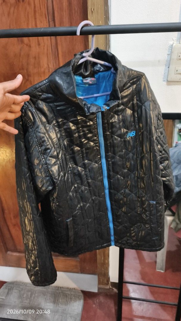 New Balance Quilted Jacket Black Blue Size M (Category: Coats, Jackets and Outerwear) located in Baguio. Submitted by monde_46 (Listing ID 1468303885, Image 2). Description: - Brand: New Balance - Style: Quilted puffer jacket with stand-up collar - Color: Black with bright blue inner lining and zipper - Logo: Small blue embroidered New Balance logo on left chest - Size: Medium - Condition: Excellent casual layer for cold weather - Mode of Payment