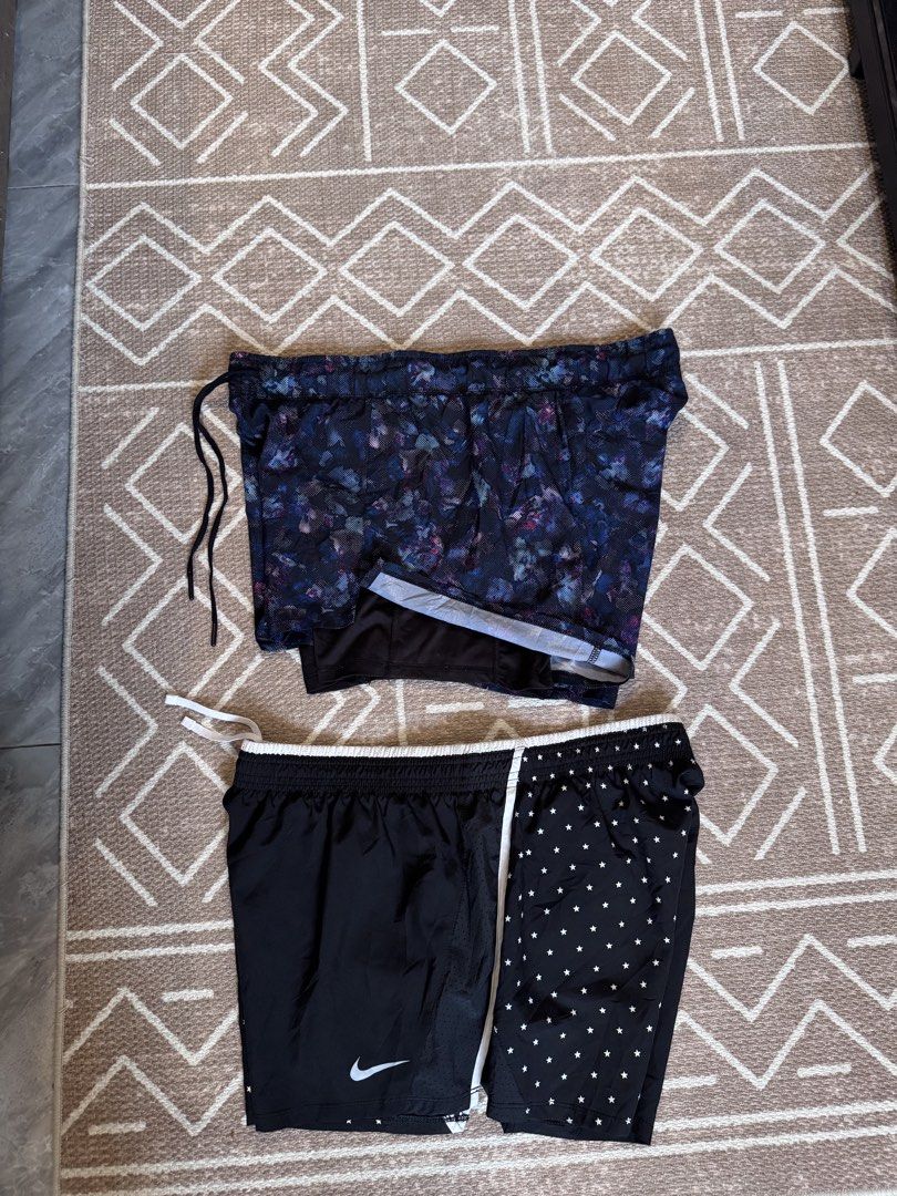 Nike and Avia athletic shorts bundle size L (Category: Shorts) located in Bulacan. Submitted by zyannechlo86360 (Listing ID 1468413421, Image 1). Description: Two pairs of athletic shorts. One pair is Nike with a star pattern and white drawstring waist. Second pair is Avia with a dark floral and abstract pattern, inner lining included. Both shorts feature elastic waistbands. Great for workouts, running, or casual gym wear. Size L for kids or yout