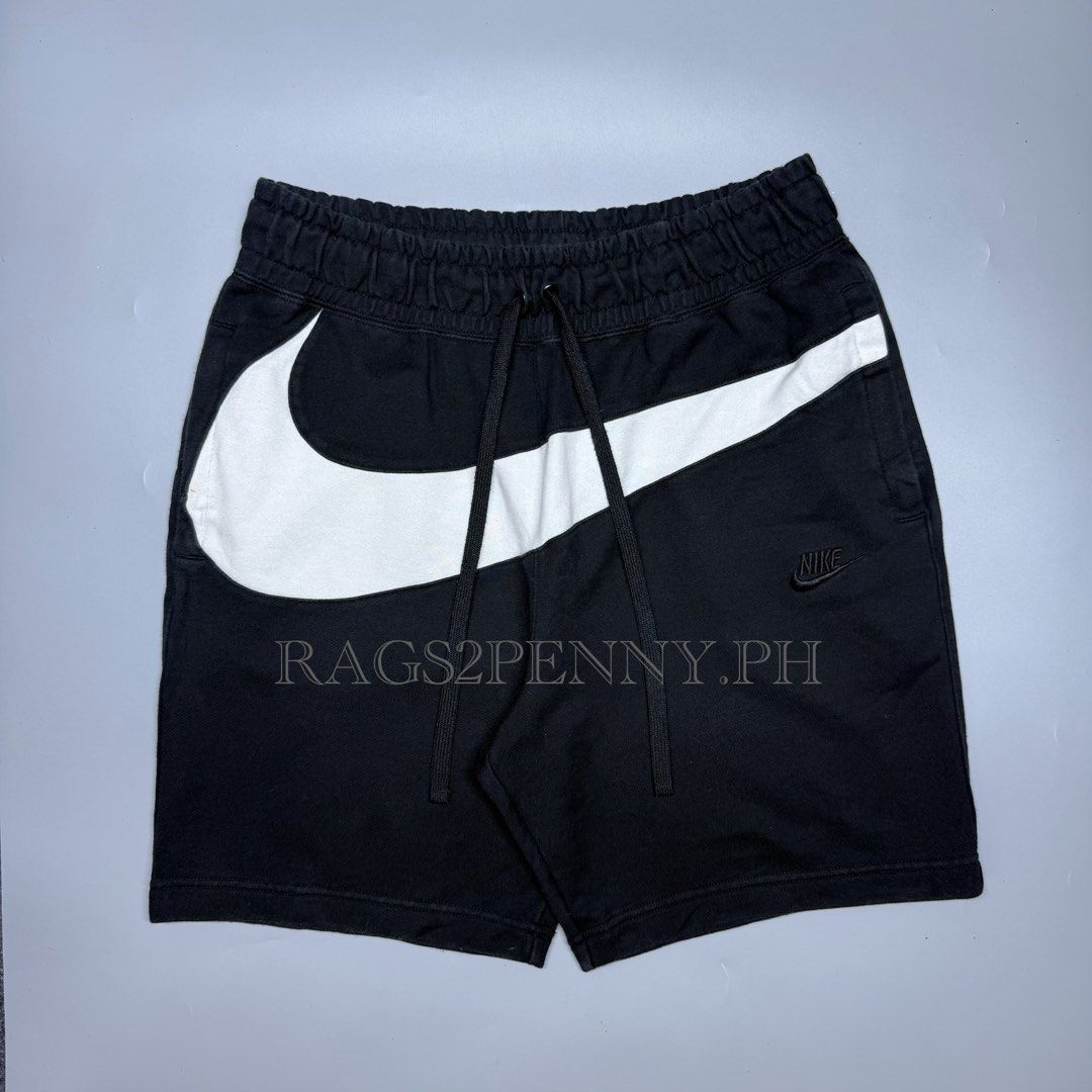 Nike Big Swoosh (Category: Shorts) located in Kabacan. Submitted by rags2penny.phl (Listing ID 1468331378, Image 1). Description: - Brand: Nike - Style: Giant Swoosh Fleece Shorts - Color: Black and White - Size: XXL - Style Code: AR3162-010 - Material: Warm and comfortable cotton blend - Features: Giant front swoosh graphic, small embroidered swoosh on leg, and elastic waistband with adjustable drawstrings - Perfect for daily wear, workouts, or 