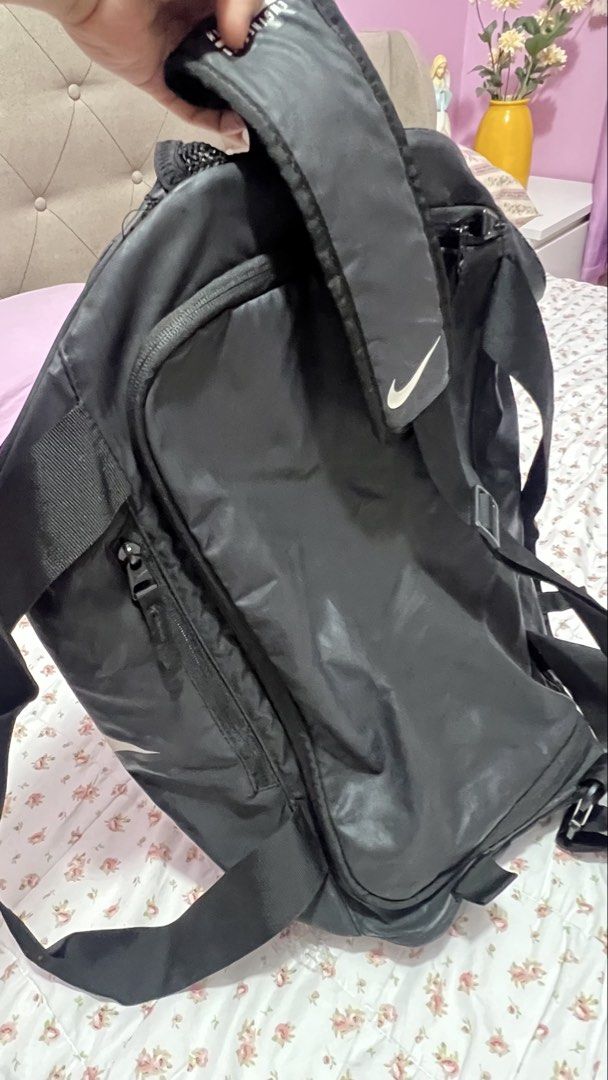Nike Black Large Logo Duffle Backpack Engineered Carry System (Category: Backpacks) located in Pasig City. Submitted by morilove (Listing ID 1468296565, Image 2). Description: - Authentic Nike duffle backpack in black with a massive white logo - Engineered carry system with comfortable padded straps - Large main compartment with smooth zippers and a convenient side zip pocket - Spacious grey-lined interior for all your essentials - Ideal for gym 