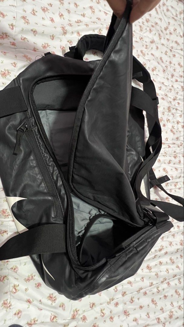 Nike Black Large Logo Duffle Backpack Engineered Carry System (Category: Backpacks) located in Pasig City. Submitted by morilove (Listing ID 1468296565, Image 3). Description: - Authentic Nike duffle backpack in black with a massive white logo - Engineered carry system with comfortable padded straps - Large main compartment with smooth zippers and a convenient side zip pocket - Spacious grey-lined interior for all your essentials - Ideal for gym 