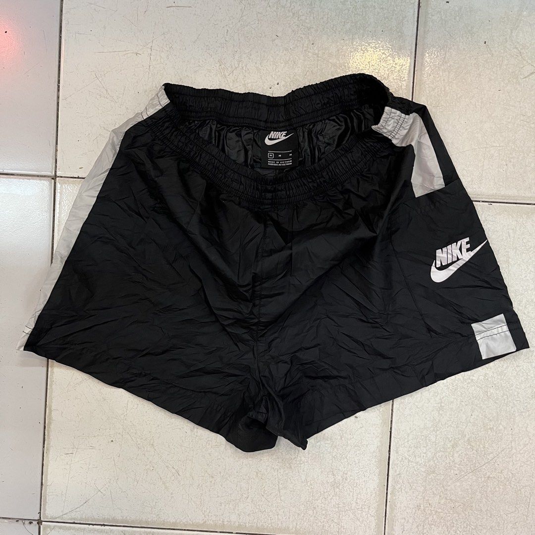 Nike Black Nylon Shorts Size M (Category: Shorts) located in Cebu City. Submitted by booksii3232 (Listing ID 1468311568, Image 2). Description: - Brand: Nike - Item: Nylon Shorts - Color: Black with white stripe details - Size: Medium (M) - Material: 100% polyester - Origin: Made in Vietnam - Features: Elastic waistband and bold Nike logo print - Condition: Good, ready to wear.