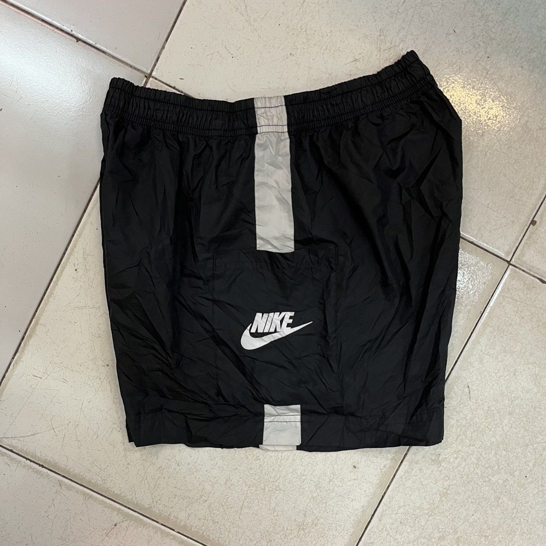 Nike Black Nylon Shorts Size M (Category: Shorts) located in Cebu City. Submitted by booksii3232 (Listing ID 1468311568, Image 1). Description: - Brand: Nike - Item: Nylon Shorts - Color: Black with white stripe details - Size: Medium (M) - Material: 100% polyester - Origin: Made in Vietnam - Features: Elastic waistband and bold Nike logo print - Condition: Good, ready to wear.