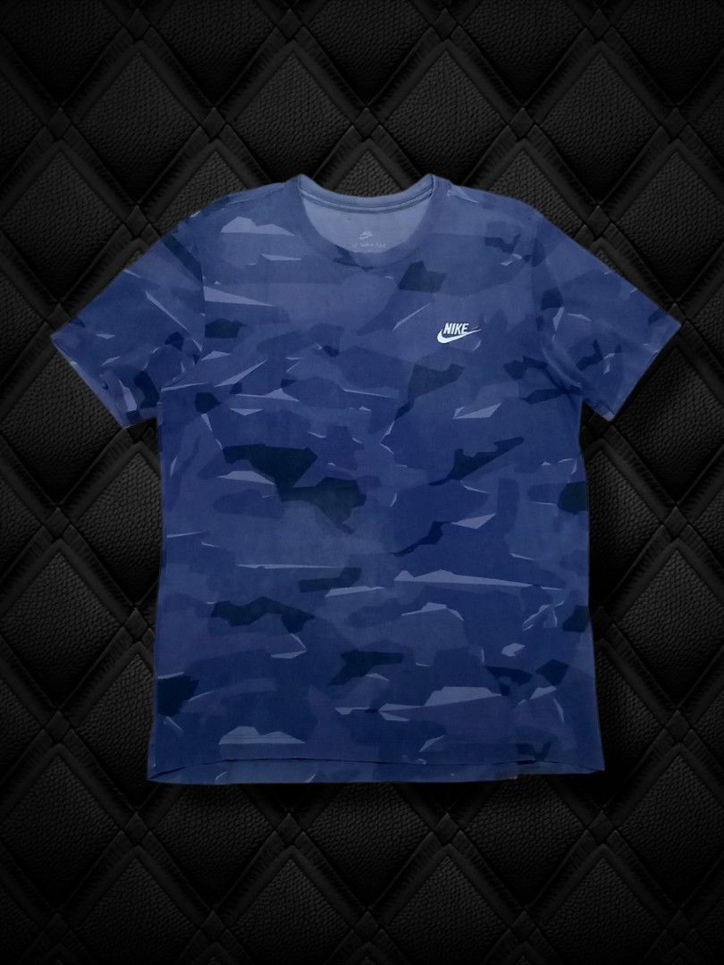 Nike Blue Camo T-Shirt I Tee (Category: Tshirts & Polo Shirts ) located in Aguinaldo. Submitted by ukayandthrift (Listing ID 1468328672, Image 1). Description: - Brand: Nike - Design: Blue geometric camo print with white chest swoosh - Style: Short sleeves, crew neck, standard fit - Material: Lightweight and breathable cotton - Condition: Excellent, clean fabric with no stains or holes - Best for: Casual wear or workouts - Fast shipping available