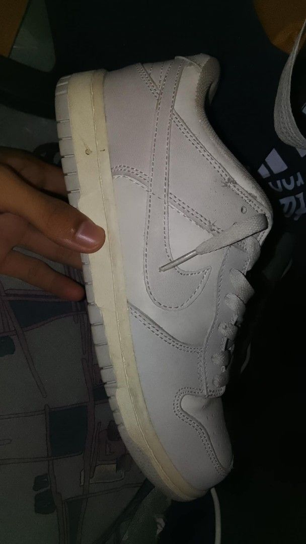 Nike Dunk Low White Sneakers (Category: Sneakers) located in Manila. Submitted by hstlvst (Listing ID 1468355256, Image 1). Description: - Model: White Nike Dunk Low - Style: Classic low-top with lace-up front and leather upper - Details: Standard perforation on toe box, clean overall profile - Condition: Ready to wear, soles have minor yellowish aging from storage.