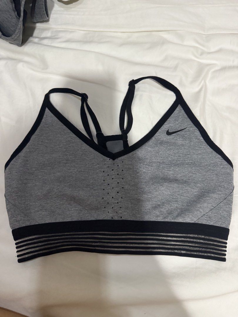 Nike Grey Sports Bra Size M (Category: Activewear) located in Manila. Submitted by bellafleur (Listing ID 1468397525, Image 1). Description: - Brand: Nike - Color: Grey and Black - Size: Medium (M) - Design: Strappy back with adjustable straps - Support: Striped elastic underband - Breathability: Mesh paneling in center/back and front perforations - Material: Polyester and spandex blend - Origin: Made in Sri Lanka.