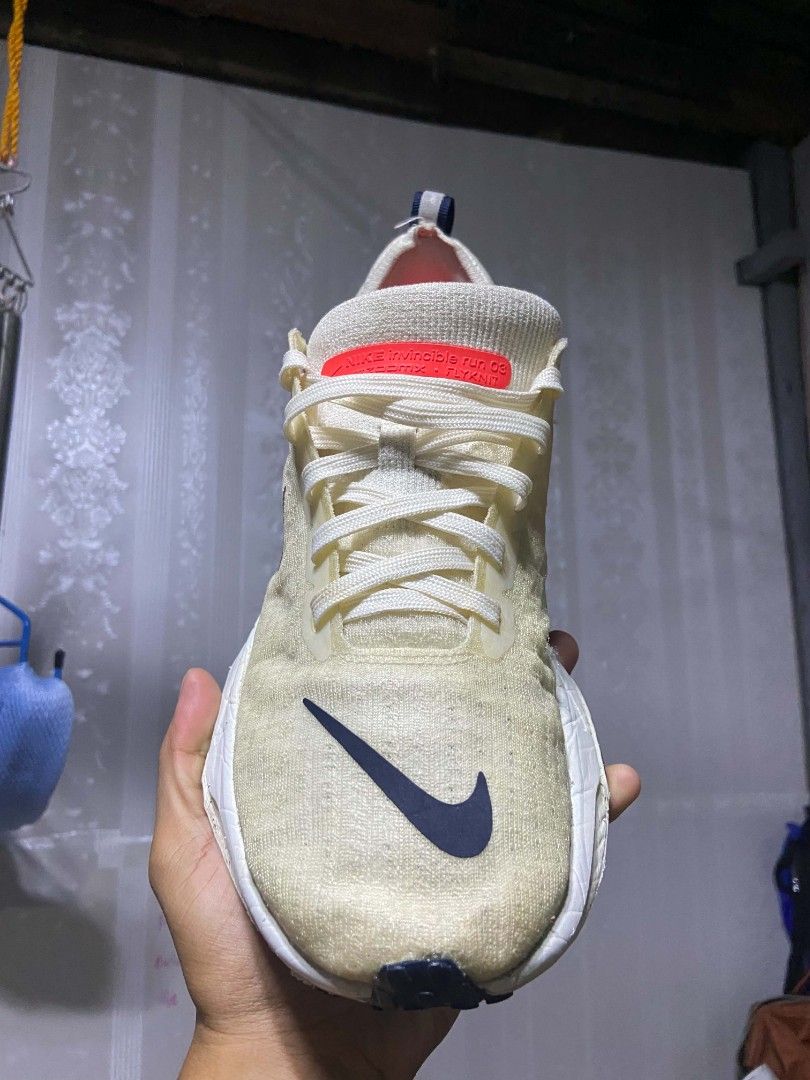 Nike Invincible Run 3 ZoomX Flyknit Cream (Category: Sneakers) located in Manila. Submitted by alexson10 (Listing ID 1468448571, Image 3). Description: - Brand: Nike Invincible Run 3 ZoomX Flyknit - Colorway: Cream upper with navy swoosh and red accents - Cushioning: Thick ZoomX foam midsole for maximum comfort - Features: Lace-up closure with convenient heel pull tabs - Condition: Pre-loved with noticeable signs of wear on the uppers and midsole