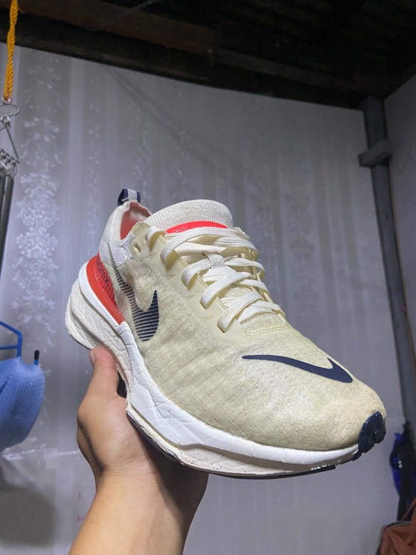 Nike Invincible Run 3 ZoomX Flyknit Cream (Category: Sneakers) located in Manila. Submitted by alexson10 (Listing ID 1468448571, Image 2). Description: - Brand: Nike Invincible Run 3 ZoomX Flyknit - Colorway: Cream upper with navy swoosh and red accents - Cushioning: Thick ZoomX foam midsole for maximum comfort - Features: Lace-up closure with convenient heel pull tabs - Condition: Pre-loved with noticeable signs of wear on the uppers and midsole