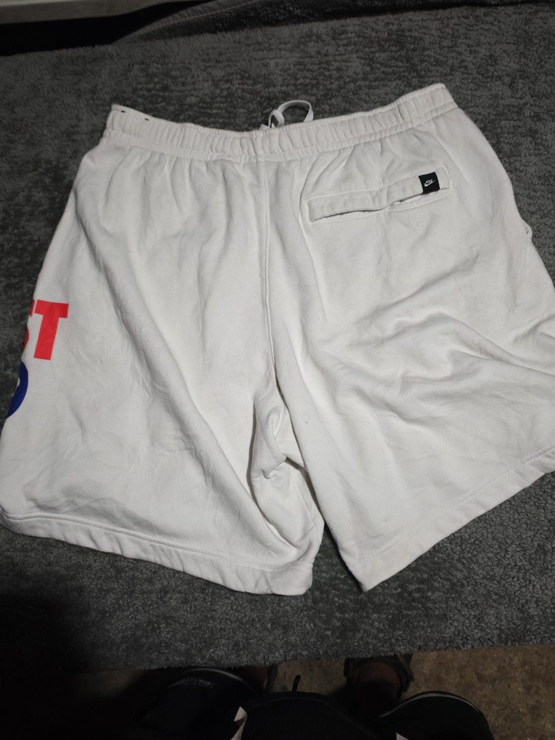 Nike Just Do It Sweatshorts White (Category: Shorts) located in Dalaguete. Submitted by three7archives (Listing ID 1468442632, Image 2). Description: - Color: White with colorful Just Do It leg print - Material: Comfortable cotton fleece - Features: Drawstring waistband, 2 front pockets, 1 back pocket with Nike logo tag - Fit: Regular - Best for: Lounging or casual workouts - Delivery: Pick up or local meetup available.