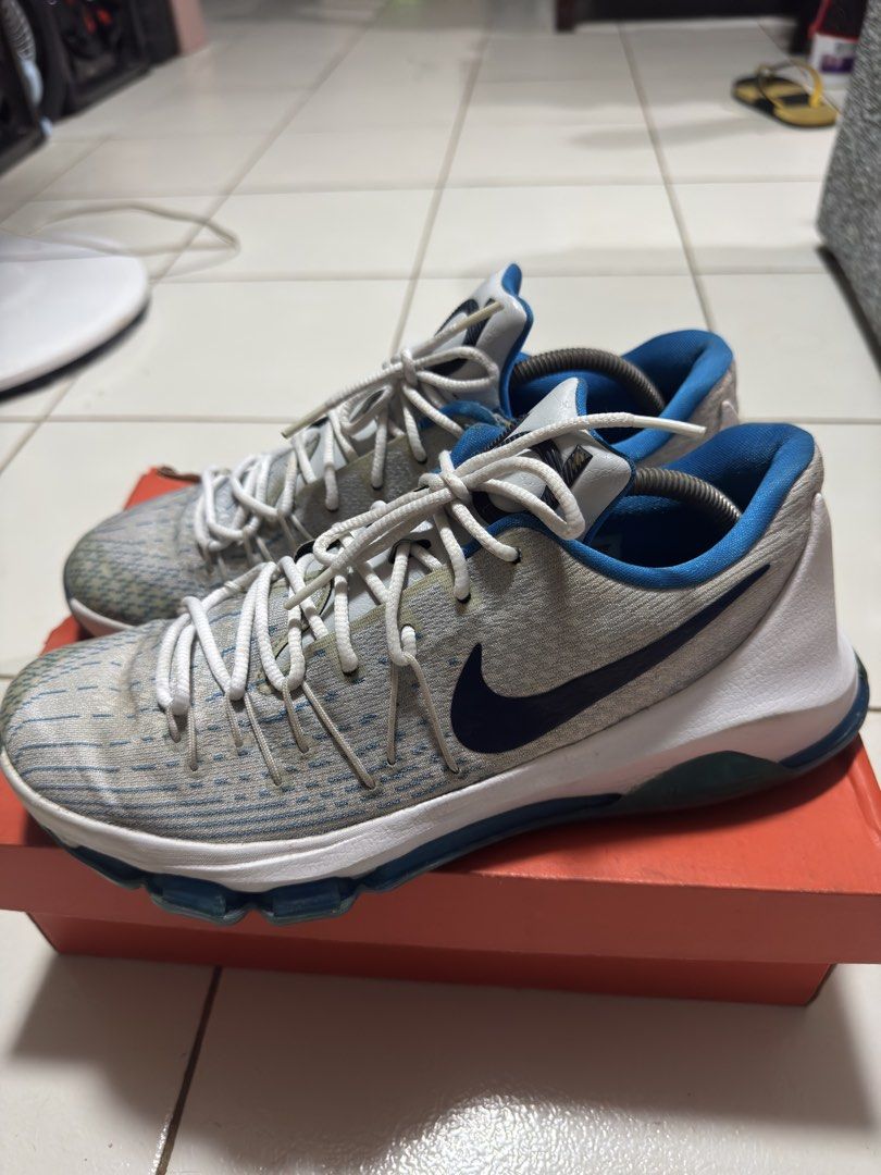 Nike KD 8 Photo Blue (Category: Sneakers) located in Manila. Submitted by mislangers_stuff (Listing ID 1468372633, Image 3). Description: - Brand/Model: Nike KD 8 basketball shoes - Colorway: Grey and blue with white laces and dark blue swoosh - Details: Signature KD branding on the tongue and heel counter, textured knit upper - Condition: Visible wear and yellowish discoloration on the toe area and lace loops; outsoles still have decent traction