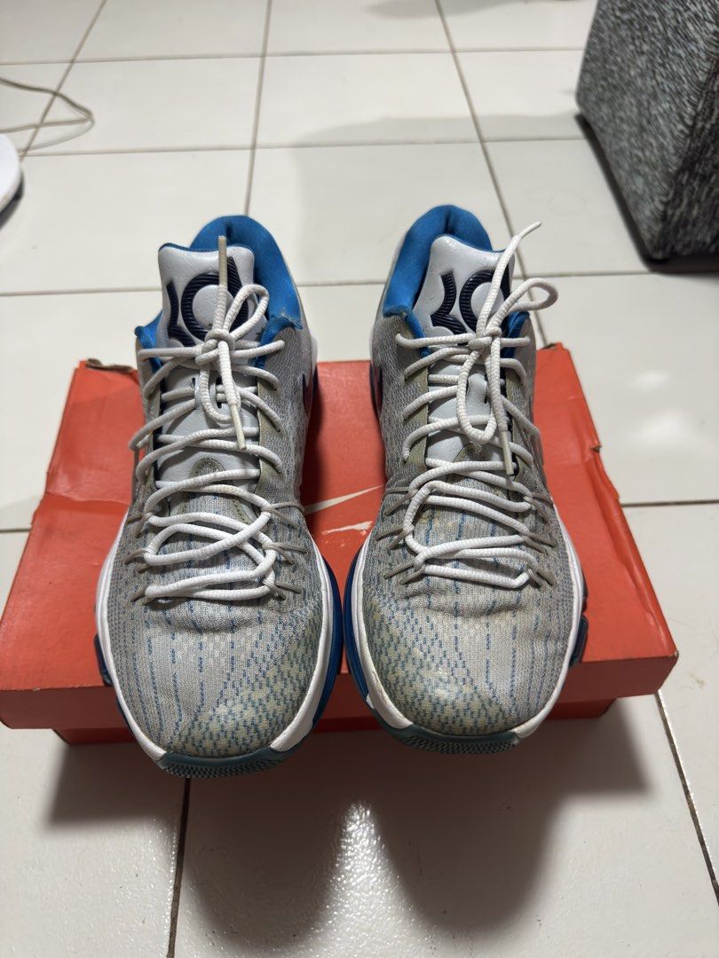 Nike KD 8 Photo Blue (Category: Sneakers) located in Manila. Submitted by mislangers_stuff (Listing ID 1468372633, Image 2). Description: - Brand/Model: Nike KD 8 basketball shoes - Colorway: Grey and blue with white laces and dark blue swoosh - Details: Signature KD branding on the tongue and heel counter, textured knit upper - Condition: Visible wear and yellowish discoloration on the toe area and lace loops; outsoles still have decent traction