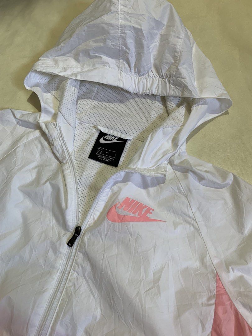Nike Pink White Windbreaker Jacket BQ6487-101 Size L (Category: Coats, Jackets and Outerwear) located in Davao. Submitted by cheineebau09680 (Listing ID 1468313721, Image 3). Description: - Brand: Nike - Style: Pink and white colorblock windbreaker jacket (Style Code: BQ6487-101) - Size: Large (tag inside) - Material & Origin: Lightweight fabric with breathable mesh lining, made in Vietnam - Features: Full zip closure and attached hood - Conditio