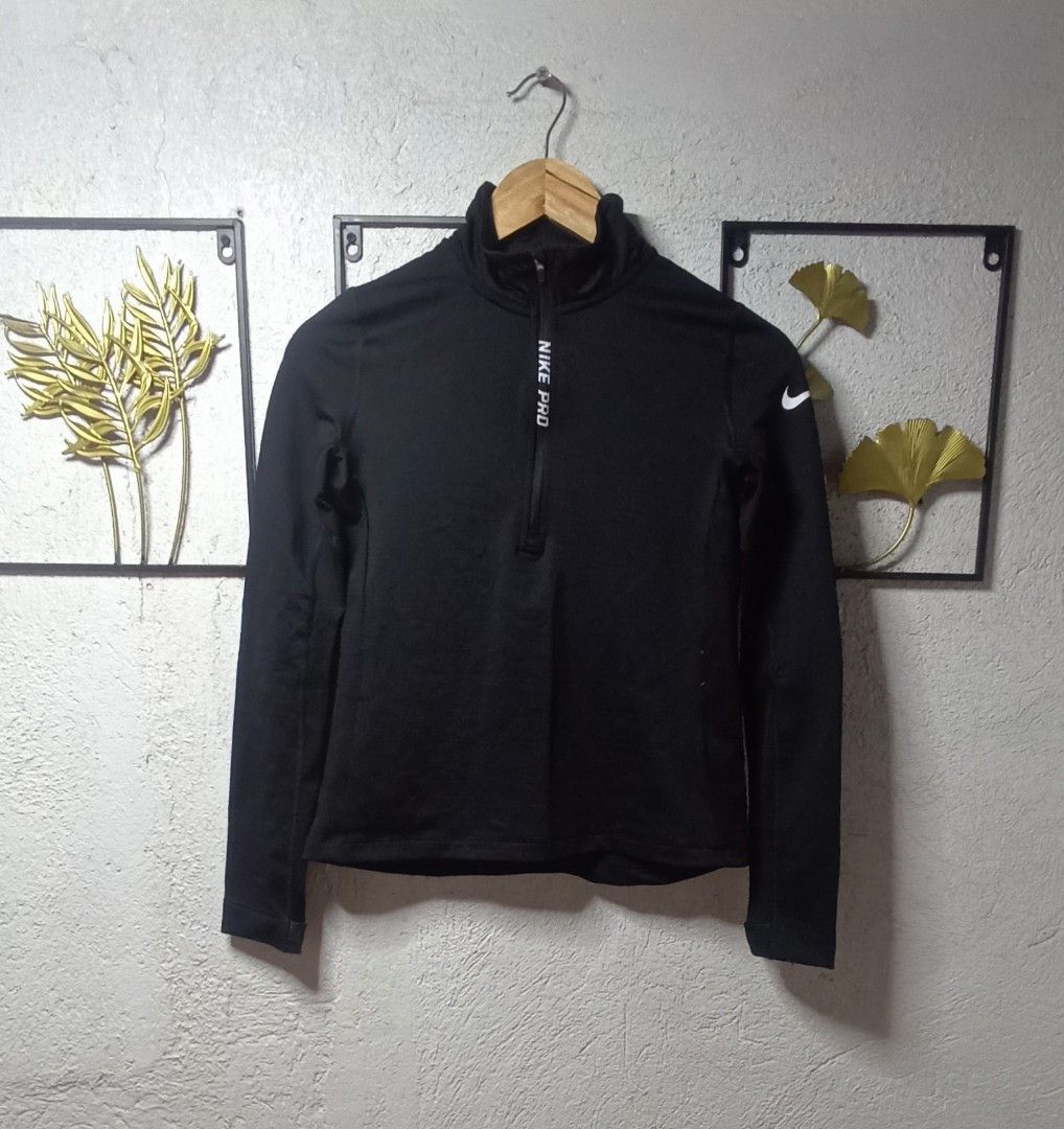 Nike Pro Hyperwarm Quarter Zip (Category: Activewear) located in Kawit. Submitted by deidzdzn (Listing ID 1468327246, Image 3). Description: - Brand: Nike Pro Hyperwarm - Color: Black with white accents - Size: Tagged L, fits like a Medium (Width: 17/20 inches, Length: 22 inches) - Design: White Nike Pro lettering along the front zipper and white swoosh logo on the sleeve - Interior: Comfortable ribbed lining for extra warmth - Condition: Great w