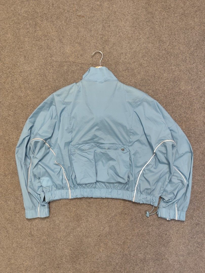 Nike Running Division Packable Windbreaker Jacket (Category: Coats, Jackets and Outerwear) located in Cordova. Submitted by bsb.streetluxvintage.clothing (Listing ID 1468423666, Image 2). Description: - Brand: Nike - Color: Light Blue - Size: Small - Full front zip closure with snap button collar - Elasticated hem and cuffs for a secure fit - Reflective piping details along the arms for visibility - Large zippered pocket on the back - Zipped slee