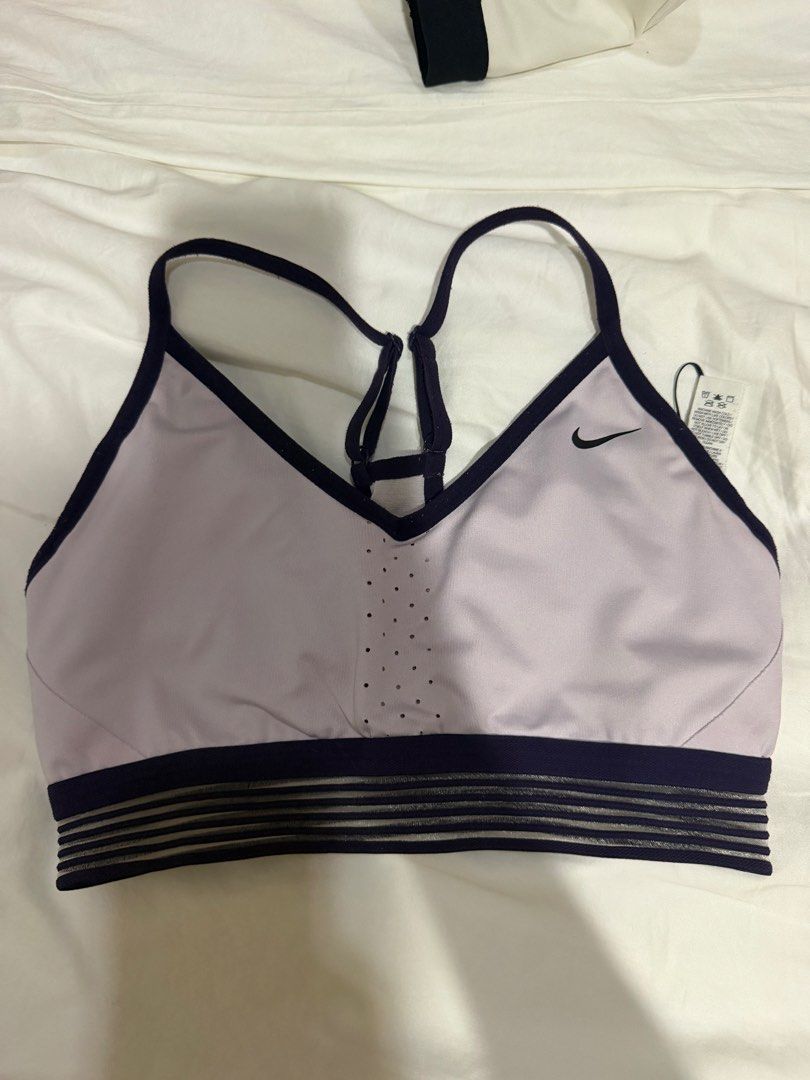 Nike Sports Bra Purple Medium (Category: Activewear) located in Manila. Submitted by bellafleur (Listing ID 1468397638, Image 1). Description: - Brand: Nike - Size: Medium - Color: Light purple with dark navy trim - Features: Perforated front center panel, breathable design - Support: Striped elastic underband & adjustable racerback straps - Origin: Made in Sri Lanka - Condition: Brand new with tag attached.