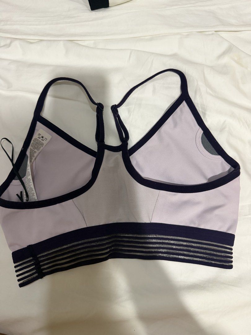 Nike Sports Bra Purple Medium (Category: Activewear) located in Manila. Submitted by bellafleur (Listing ID 1468397638, Image 2). Description: - Brand: Nike - Size: Medium - Color: Light purple with dark navy trim - Features: Perforated front center panel, breathable design - Support: Striped elastic underband & adjustable racerback straps - Origin: Made in Sri Lanka - Condition: Brand new with tag attached.