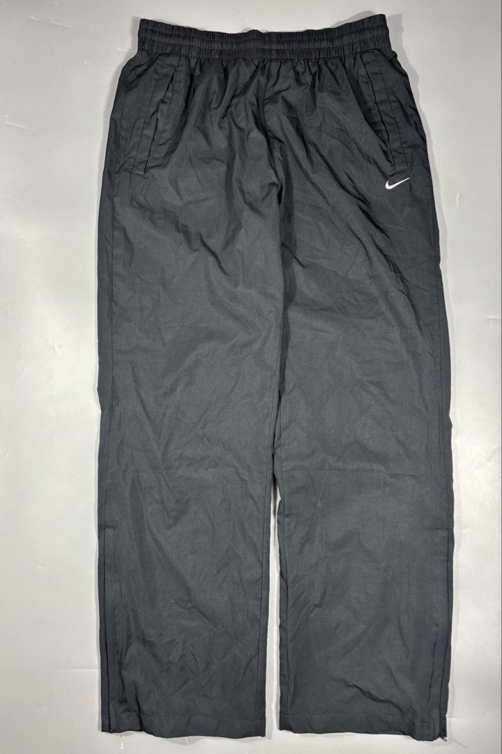 Nike Vintage Nylon Track Pants Black Large (Category: Joggers) located in Manila. Submitted by south_finds (Listing ID 1468357015, Image 2). Description: - Brand: Nike - Style: Vintage nylon track pants - Color: Black with white embroidered swoosh logo - Size: Large - Lining: Breathable mesh inner lining - Waistband: Elastic with adjustable drawstring - Pockets: Convenient side pockets included - Condition: Excellent pre-loved vintage condition.