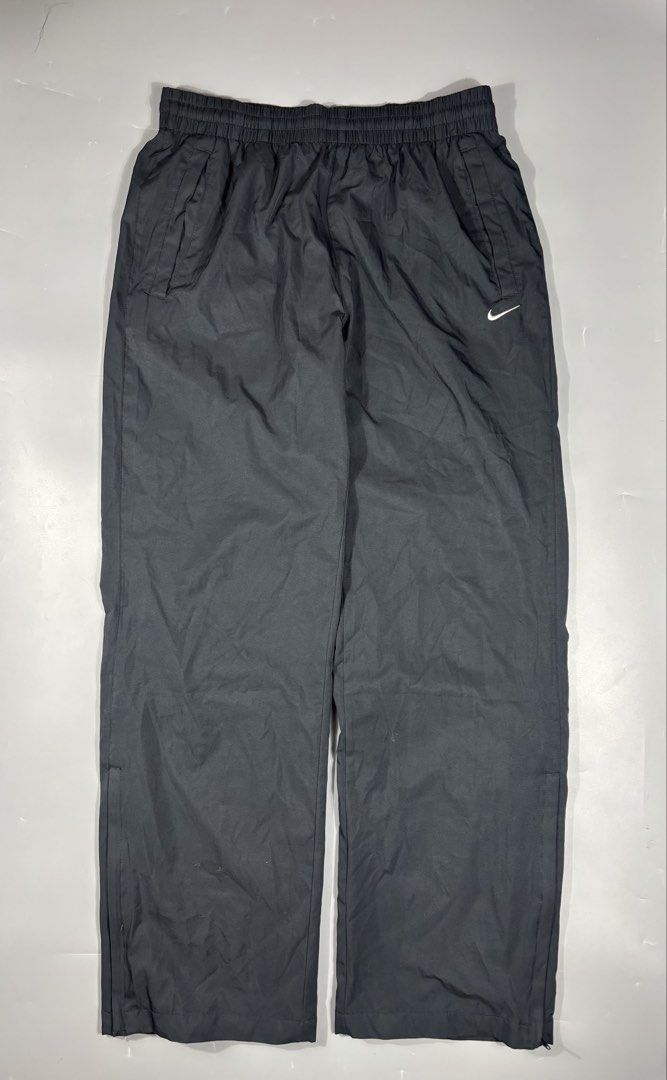 Nike Vintage Nylon Track Pants Black Large (Category: Joggers) located in Manila. Submitted by south_finds (Listing ID 1468357015, Image 1). Description: - Brand: Nike - Style: Vintage nylon track pants - Color: Black with white embroidered swoosh logo - Size: Large - Lining: Breathable mesh inner lining - Waistband: Elastic with adjustable drawstring - Pockets: Convenient side pockets included - Condition: Excellent pre-loved vintage condition.