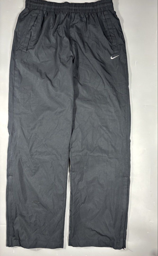 Nike Vintage Nylon Track Pants Black Large (Category: Joggers) located in Manila. Submitted by south_finds (Listing ID 1468357015, Image 3). Description: - Brand: Nike - Style: Vintage nylon track pants - Color: Black with white embroidered swoosh logo - Size: Large - Lining: Breathable mesh inner lining - Waistband: Elastic with adjustable drawstring - Pockets: Convenient side pockets included - Condition: Excellent pre-loved vintage condition.