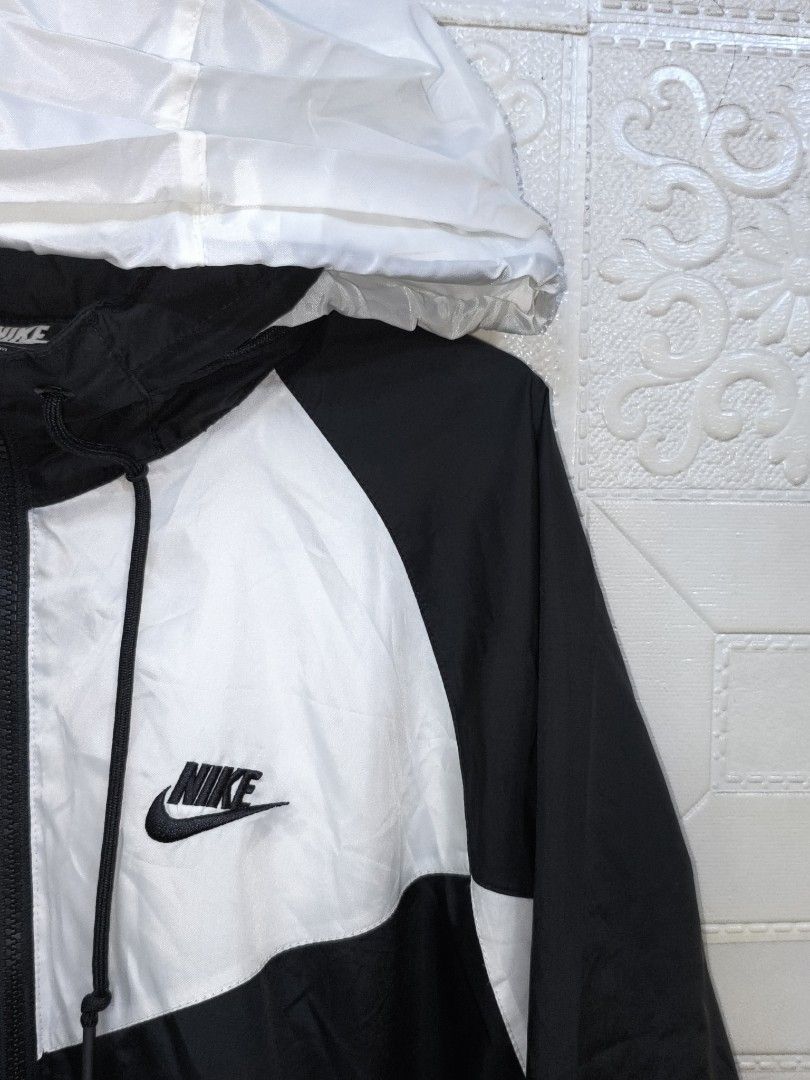 Nike Windrunner Hooded Windbreaker Jacket (Category: Coats, Jackets and Outerwear) located in Cebu City. Submitted by south_thrift (Listing ID 1468340245, Image 3). Description: Nike Windrunner Hooded Windbreaker Jacket NEGOTIABLE!!! 25" X 27" Dimensions Medium on tag Mesh inner Originally designed by Geoff Hollister in 1978, the Nike Windrunner became the face of Nike apparel through its distinctive 26-degree chevron design and functional runnin