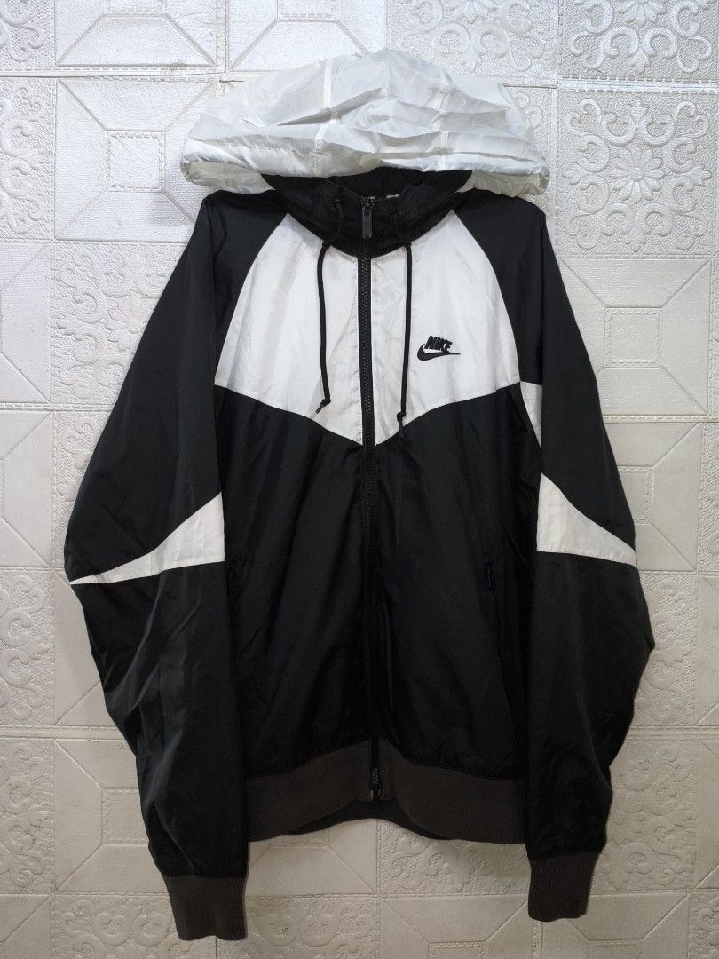 Nike Windrunner Hooded Windbreaker Jacket (Category: Coats, Jackets and Outerwear) located in Cebu City. Submitted by south_thrift (Listing ID 1468340245, Image 1). Description: Nike Windrunner Hooded Windbreaker Jacket NEGOTIABLE!!! 25" X 27" Dimensions Medium on tag Mesh inner Originally designed by Geoff Hollister in 1978, the Nike Windrunner became the face of Nike apparel through its distinctive 26-degree chevron design and functional runnin