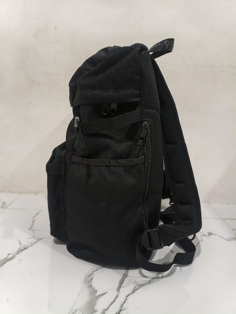 niko and... black canvas backpack (Category: Backpacks) located in Manila. Submitted by obedmagall74424 (Listing ID 1468401069, Image 3). Description: - Brand: niko and... - Color: Classic black - Material: Durable canvas with clean interior lining - Closure: Roll-top style with side buckle compression straps - Pockets: Multiple exterior zip pockets, mesh side pockets, internal zipper compartment, and open slip pockets - Comfort: Padded mesh shou