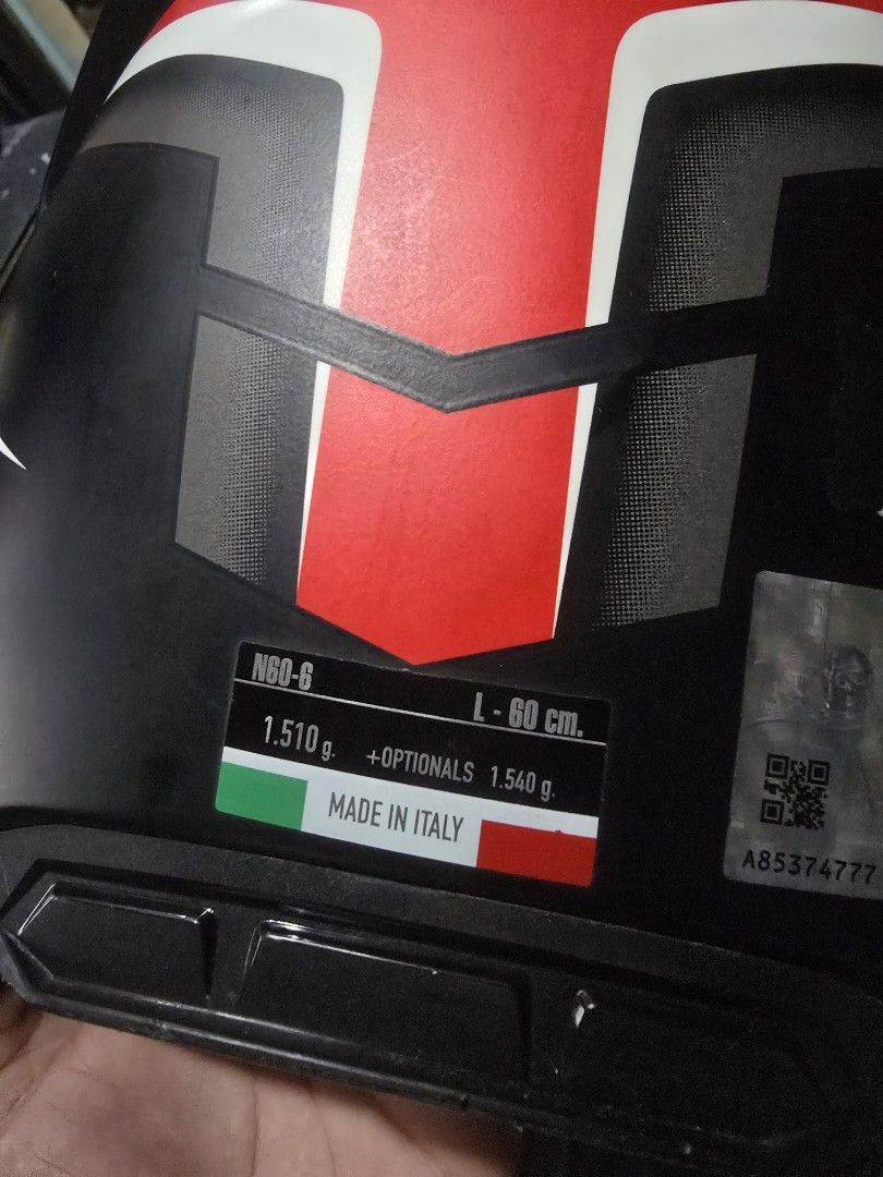 Nolan N60-6 lancer black (Category: Bicycles) located in Cavite. Submitted by s_o.l (Listing ID 1468295635, Image 2). Description: - Model: Nolan N60-6 Full Face Helmet - Colorway: Black, red, and white with graphic design - Size: L (60 cm fit) - Origin: Made in Italy - Features: Built-in sun visor and multiple ventilation ports - Closure: Secure ratchet strap - Authenticity: QR code sticker attached at the back - Condition: Clean interior paddin