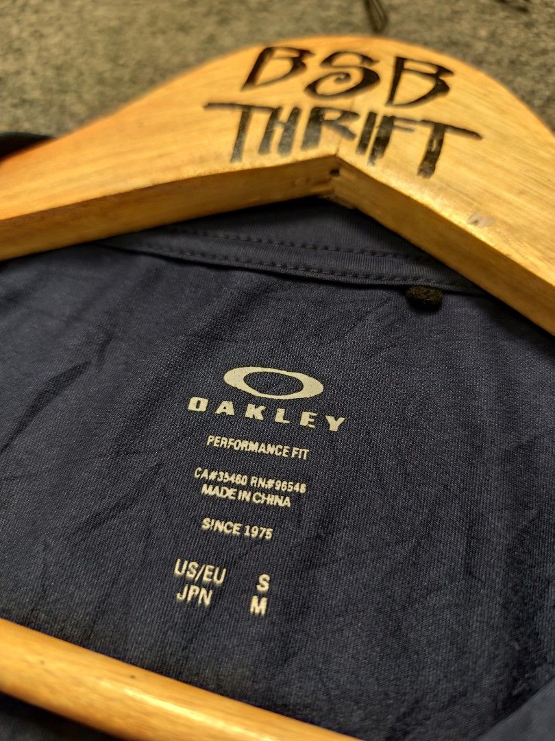 Oakley Performance Fit T-Shirt (Category: Activewear) located in Cordova. Submitted by bsb.streetluxvintage.clothing (Listing ID 1468425204, Image 3). Description: - Brand: Oakley - Color: Navy Blue - Design: Large white Oakley Ellipse logo on chest - Fit/Style: Performance fit - Material: 88% Polyester, 12% Elastane - Size: US/EU Small (JPN Medium) - Condition/Care: Made in China, machine washable.