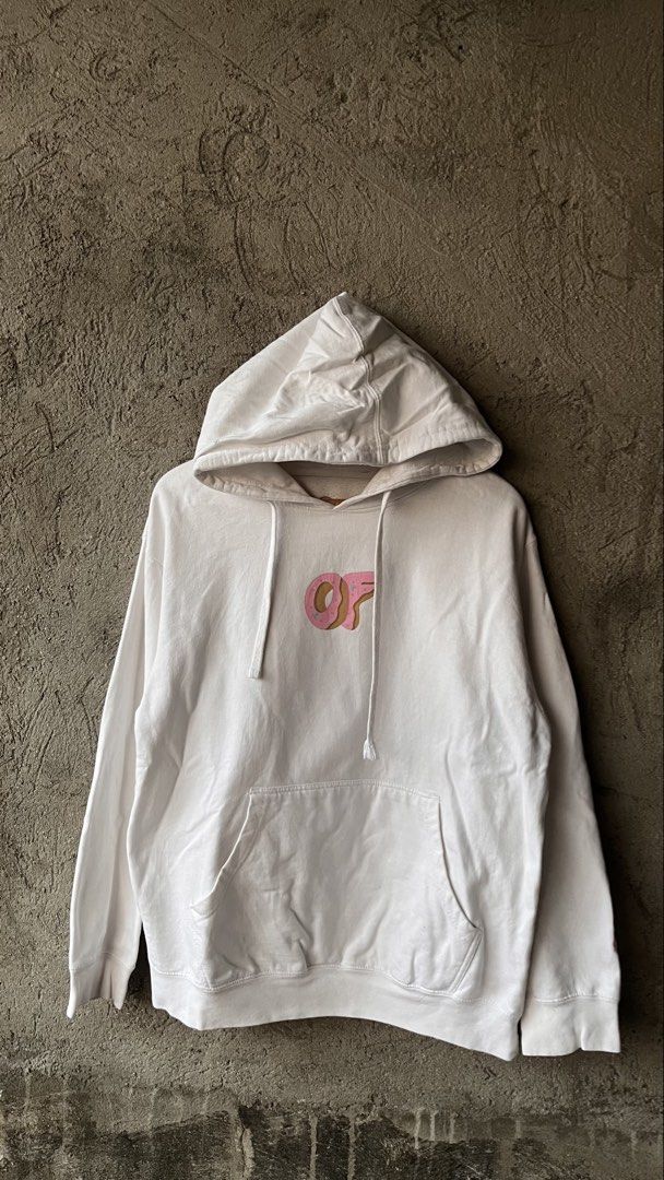 Odd Future Donut White Hoodie Size M (Category: Hoodies) located in Cabuyao City. Submitted by bulandos (Listing ID 1468379631, Image 1). Description: White Odd Future hoodie with the pink donut logo on the chest. Large graphic print on the back featuring cartoon characters around the donut, plus 'Odd Future' text down the left sleeve. Kangaroo pocket in front, drawstring hood. Size medium tag printed inside the collar. 80% cotton, 20% polyester 