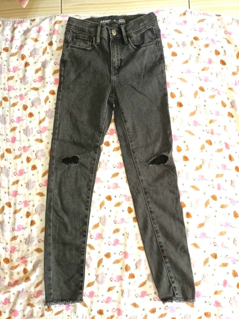 Old Navy Distressed Grey Jeans Size 10 (Category: Jeans) located in Pasig City. Submitted by zeallion_149f0e (Listing ID 1468345544, Image 1). Description: - Brand: Old Navy - Size: 10 - Color: black - Style: Distressed knees with ripped detailing and raw, frayed hems - Features: Standard button and zipper fly, belt loops, classic five-pocket setup - Condition: Great for everyday casual wear.