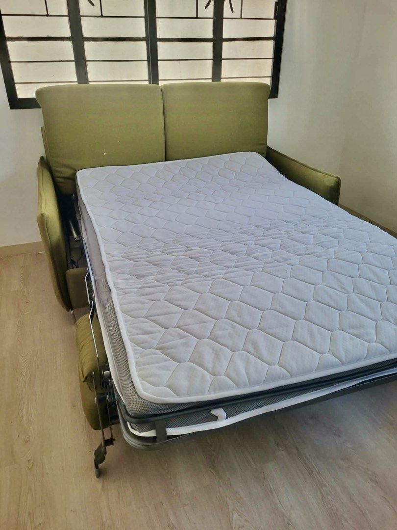 Olive green convertible sofa bed with pull-out mattress (Category: Sofas) located in Taguig. Submitted by manilafortrealty.ph (Listing ID 1468317428, Image 3). Description: For sale 2 seater Italian sofa bed Price at 250k if brand new just selling it 25k -with mattress - Color: Stylish olive green - Capacity: Seats 2 comfortably - Function: Converts easily into a proper bed - Mattress: Includes a built-in quilted mattress with a smooth metal pull