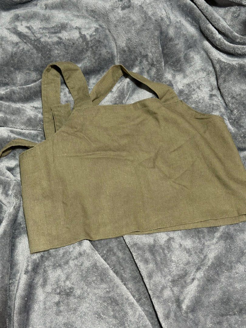 Olive green crop top with thick straps (Category: Sleeveless) located in Manila. Submitted by nixfinds.co (Listing ID 1468328389, Image 1). Description: - Color: Olive green - Style: Square neckline crop top with thick crisscross back straps - Material: Heavy linen-like fabric that holds its shape well - Fit: Cropped length, ideal for high-waisted denim or skirts - Condition: Clean, no stains or loose threads.