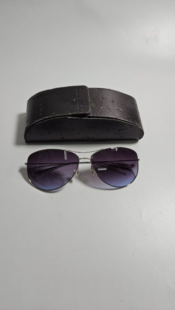 Oliver Peoples Strummer T sunglasses (Category: Sunglasses & Eyewear) located in Alfonso. Submitted by jbcamet (Listing ID 1468387357, Image 2). Description: - in pristine condition - no scratches sa glass - Style: Classic aviator sunglasses - Frame: Silver-tone metal with comfortable nose pads - Lenses: Gradient purple tinted - Inclusion: Original dark hard case with embossed branding - Condition: Great for everyday use, sunny days, or driving -